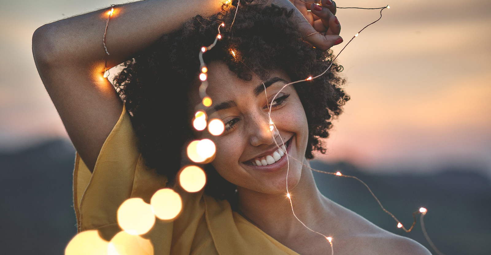 girl smiling with lights