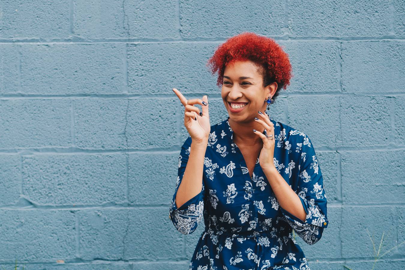 women pointing finger and smiling